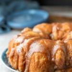 Platter of monkey bread on a blue plate next to two blue plates