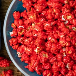 Blue dish full of red hot cinnamon popcorn