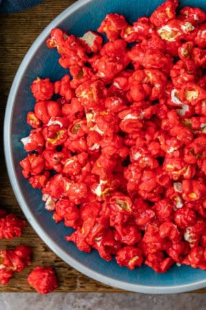 Blue dish full of red hot cinnamon popcorn