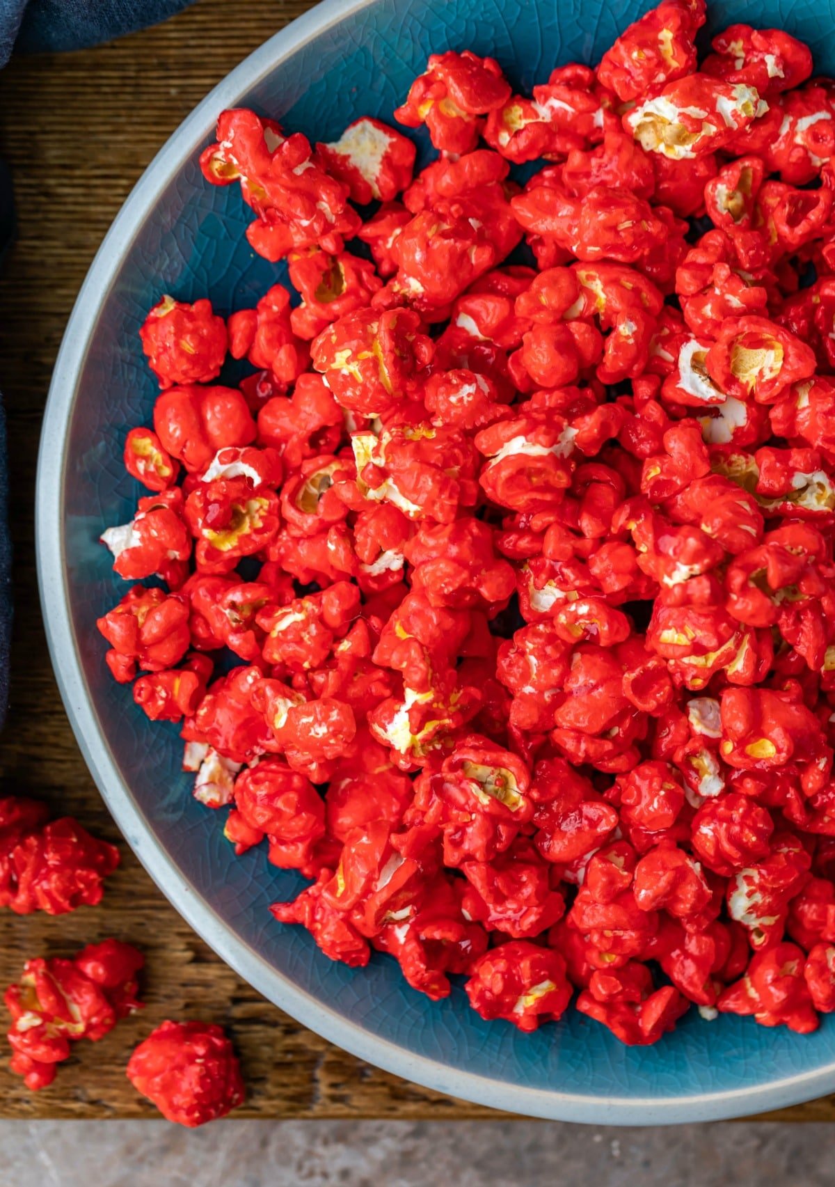 Blue dish full of red hot cinnamon popcorn