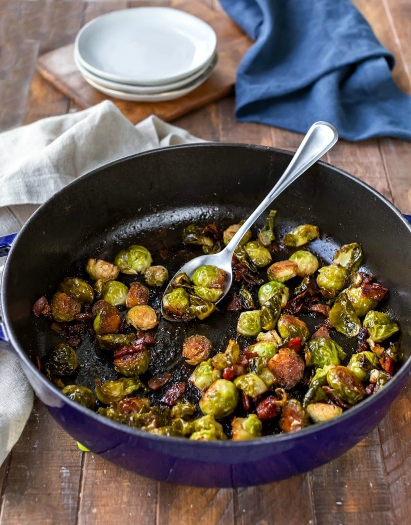 Maple bacon balsamic brussels sprouts in a blue enamel cast iron skillet