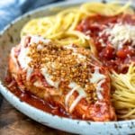 Slow cooker chicken parmesan on a speckled plate