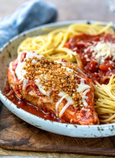 Slow cooker chicken parmesan on a speckled plate