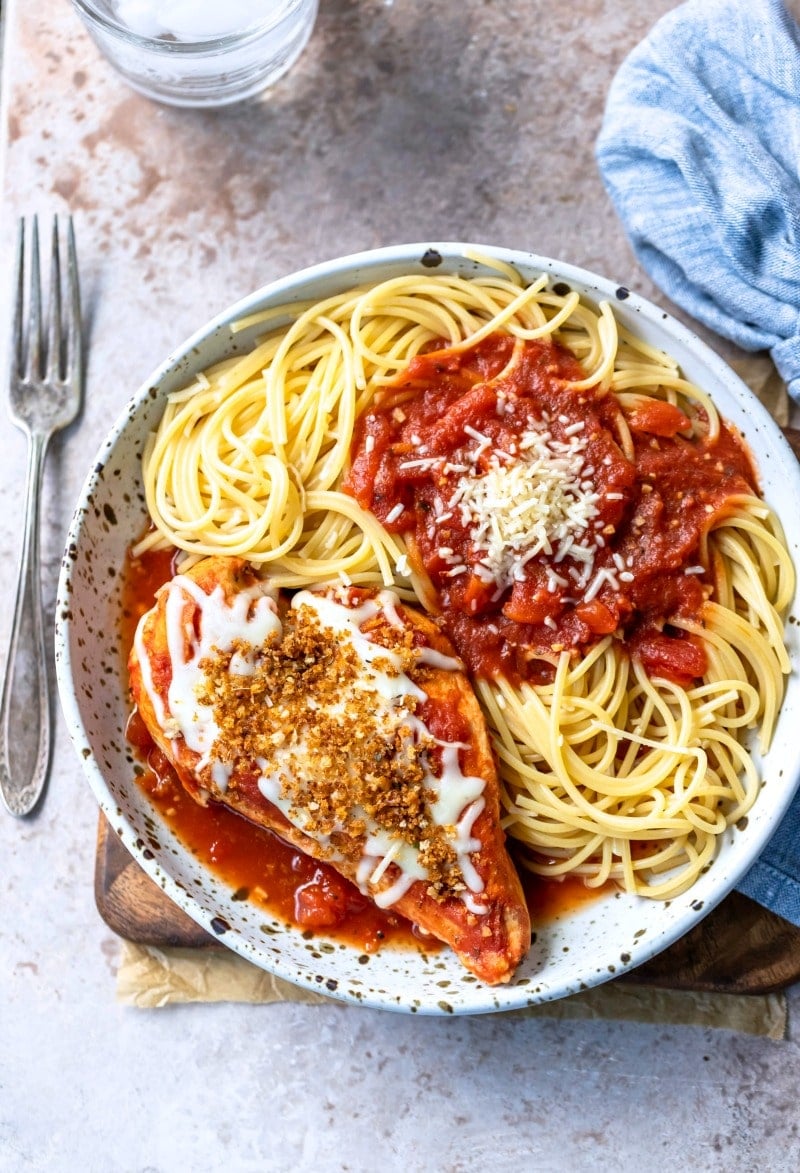 Slow Cooker chicken parmesan on a plate next to a silver fork