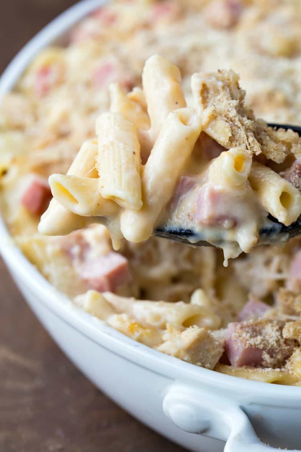 Spoon lifting up a scoop of Chicken Cordon Bleu Casserole