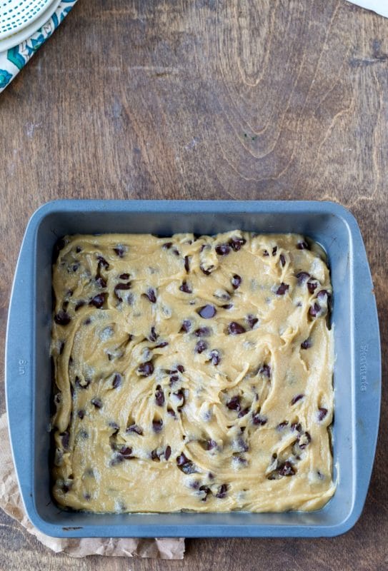 Chewy Chocolate Chip Cookie Bar dough in a metal pan