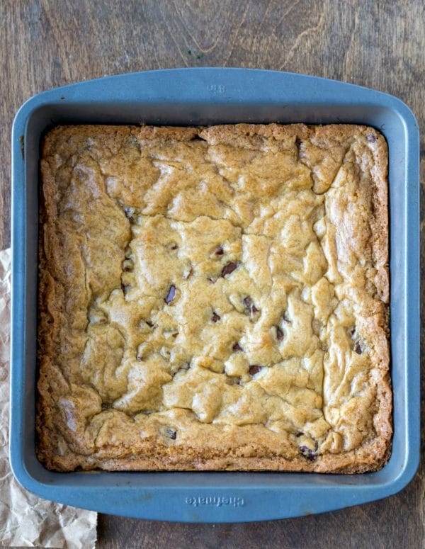 Baked chewy chocolate chip cookie bars in a pan