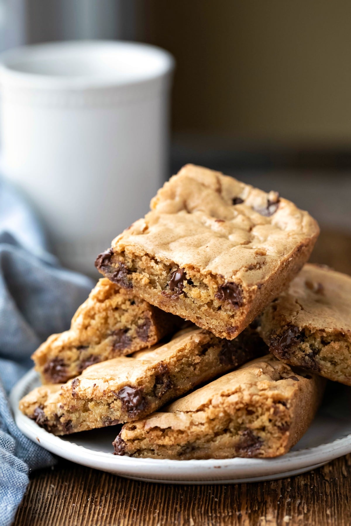 Plate of chocolate chip cookie bars on a wooden cutting board