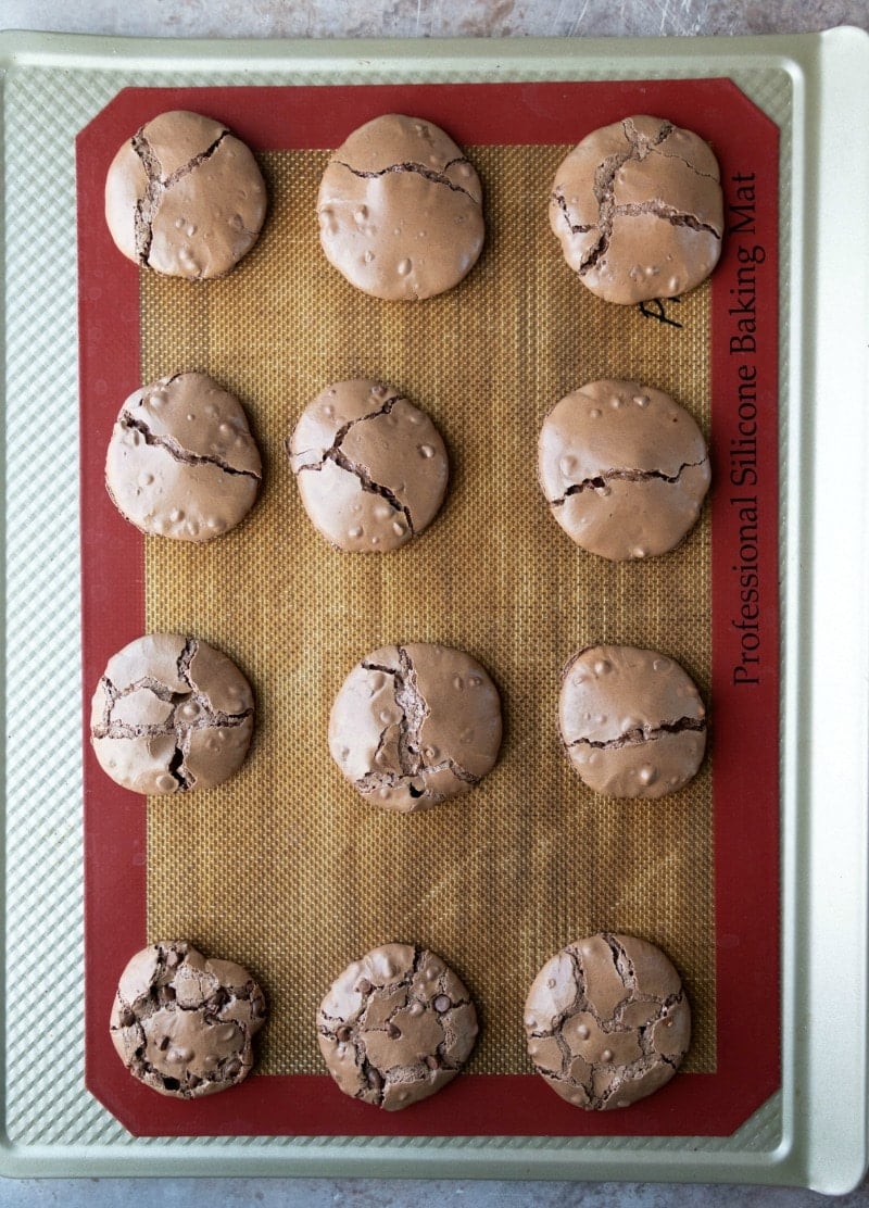 Baked flourless fudge cookies on a baking sheet