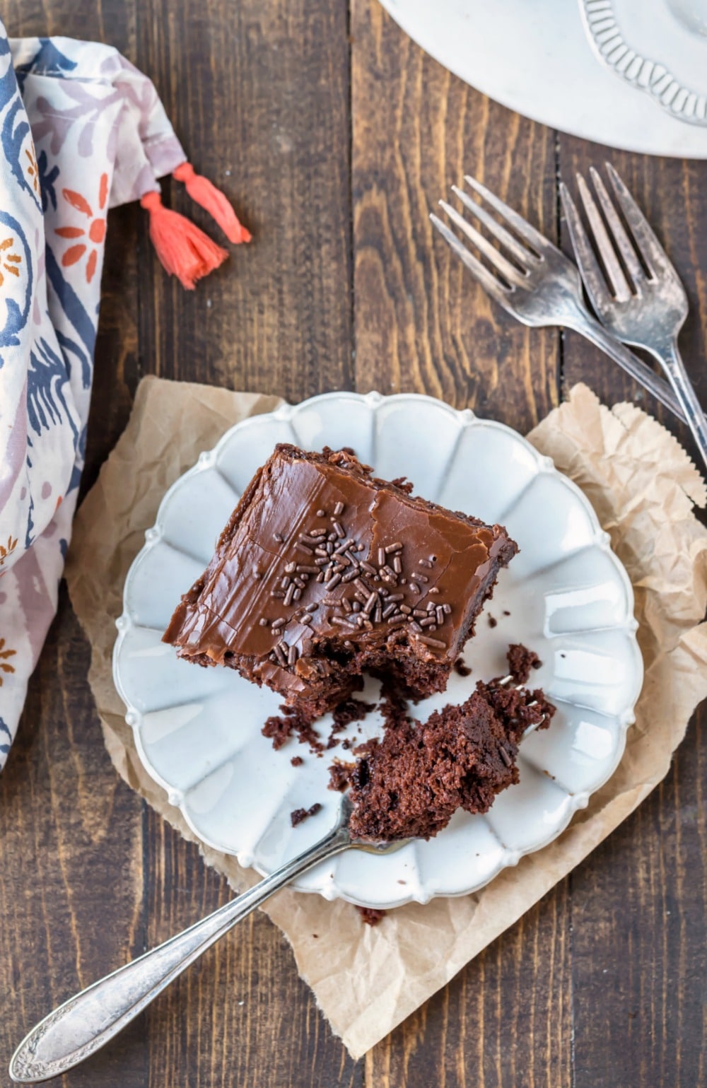 Slice of chocolate mayonnaise cake on a cream plate with a silver fork
