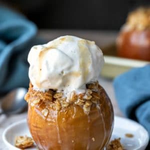 Baked apple filled with oatmeal crisp filling and topped with a scoop of vanilla ice cream