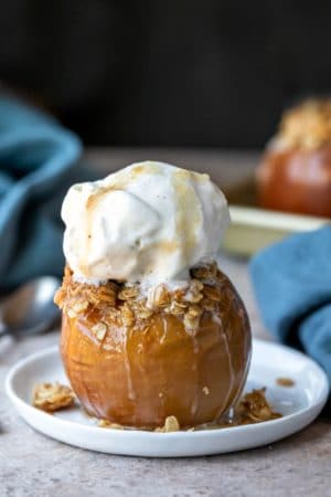 Baked apple filled with oatmeal crisp filling and topped with a scoop of vanilla ice cream