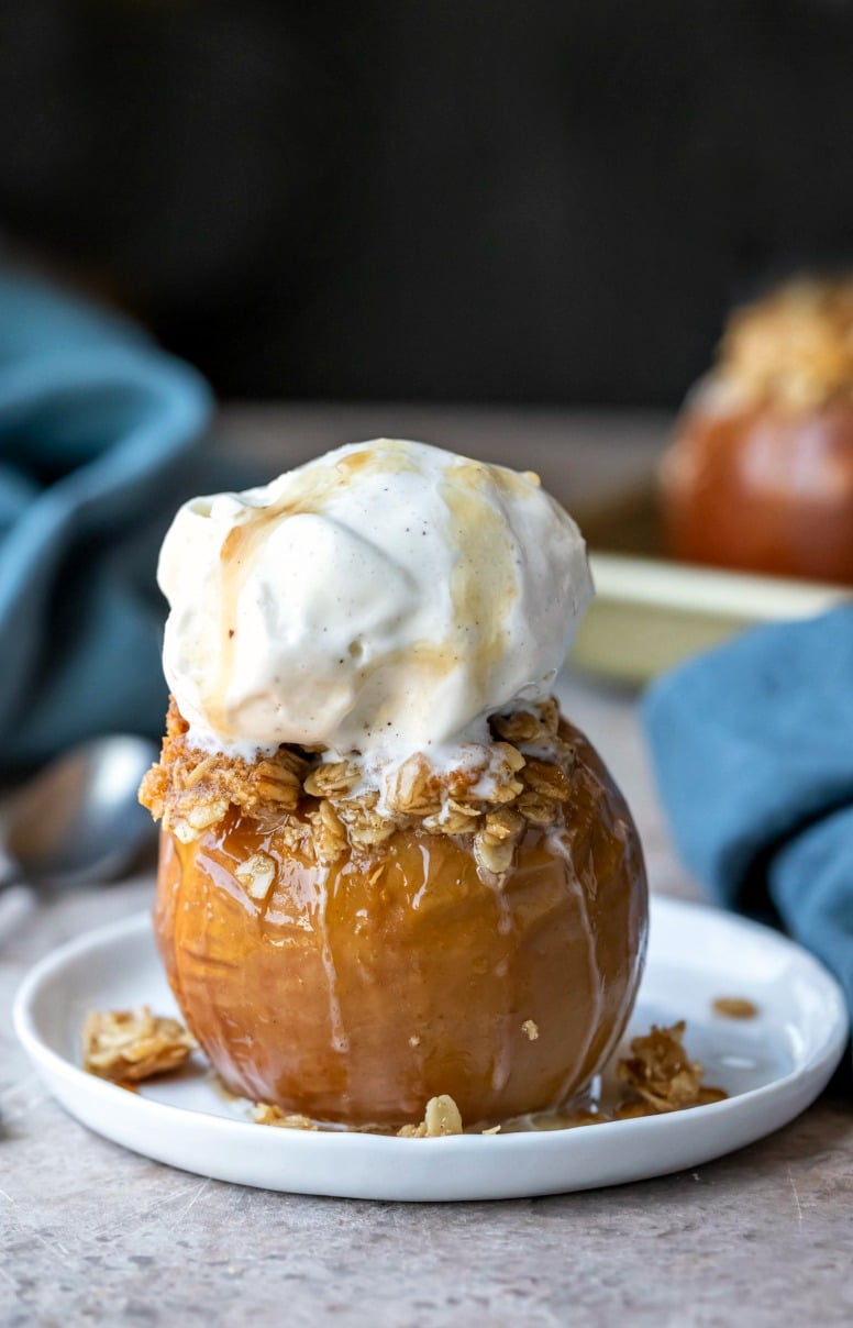 Baked apple filled with oatmeal crisp filling and topped with a scoop of vanilla ice cream