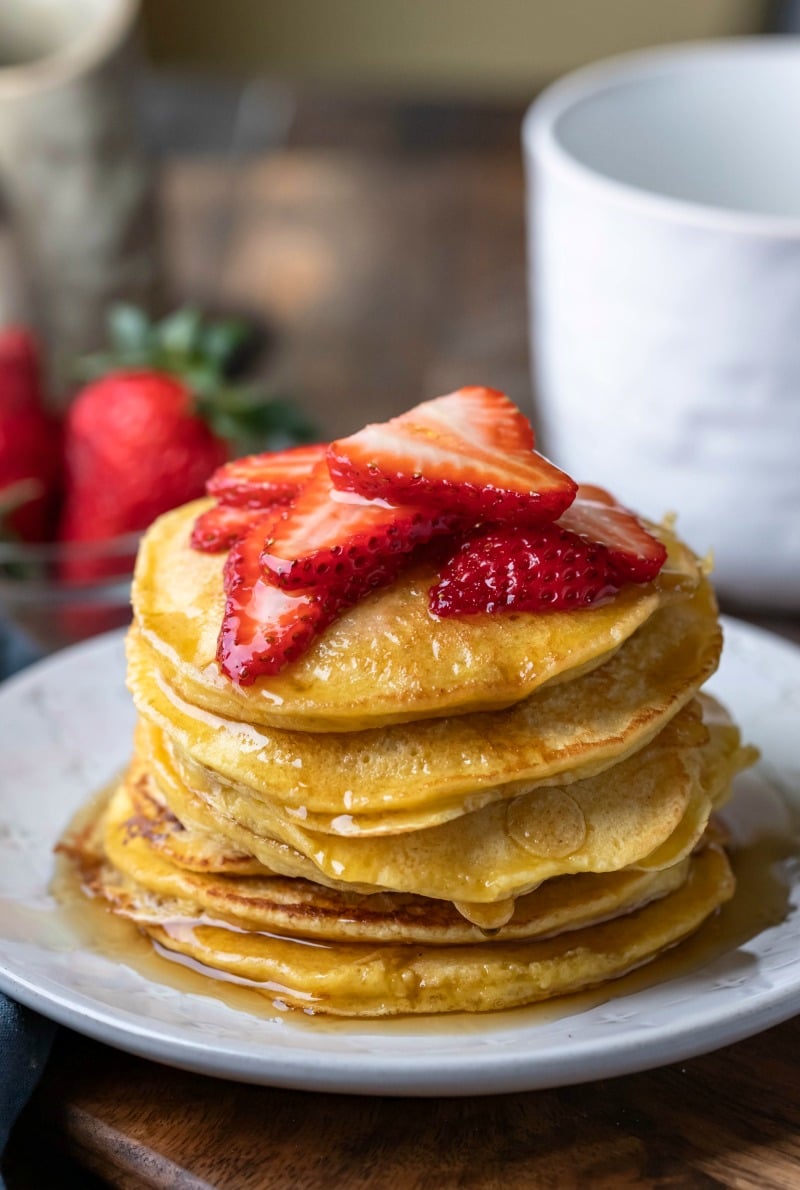 Stack of oatmeal pancakes topped with sliced strawberries
