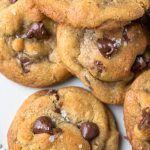 Brown Butter Chocolate Chip Cookies topped with sea salt on a white plate