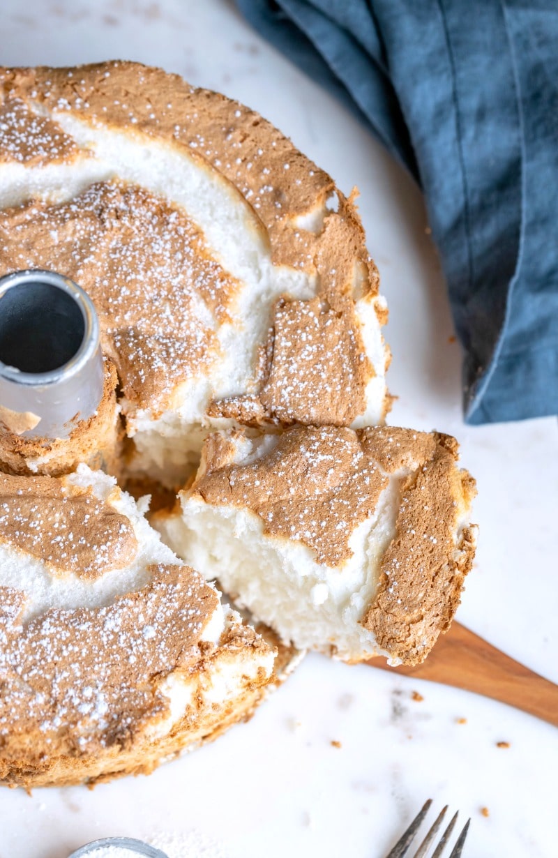 Angel food cake next to a blue linen napkin