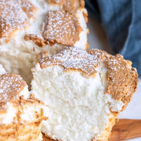 A cut slice of angel food cake on a marble background