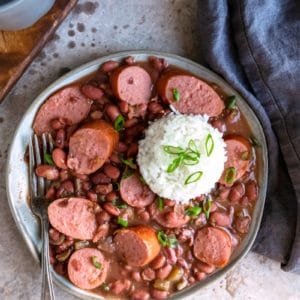 Plate of crock pot red beans and rice with a scoop of white rice