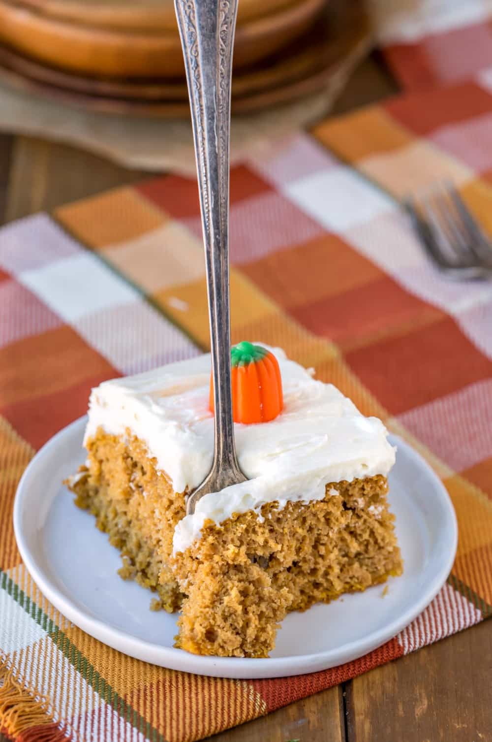 Slice of Pumpkin Spice Cake with a fork taking a bite out of it