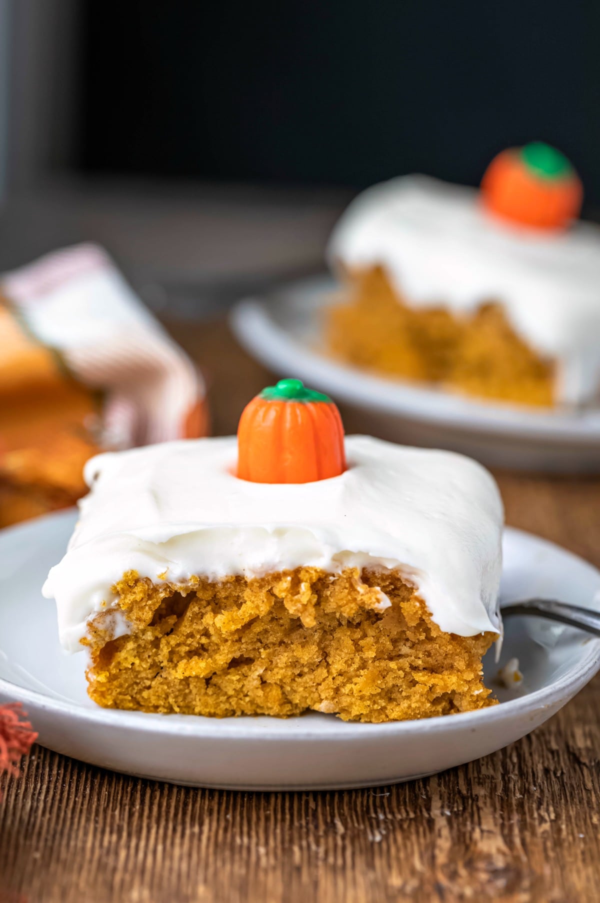 Two slices of pumpkin spice cake on white plates