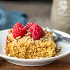 Piece of baked oatmeal topped with fresh raspberries