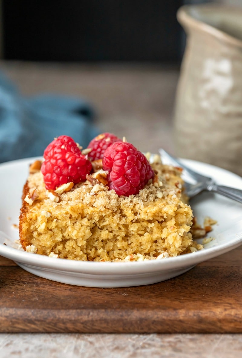 Piece of baked oatmeal topped with fresh raspberries