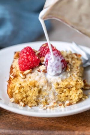 Milk pouring onto a piece of baked oatmeal