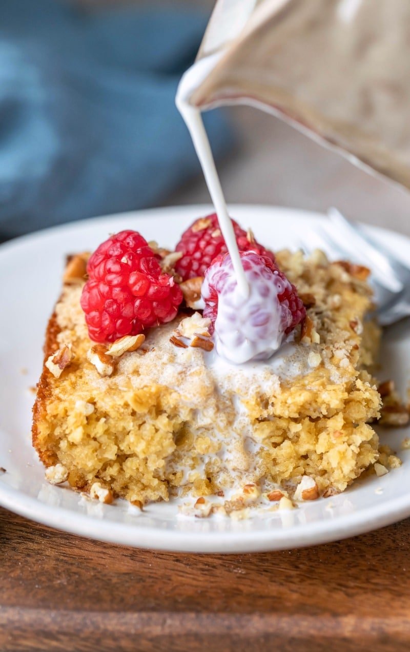 Milk pouring onto a piece of baked oatmeal