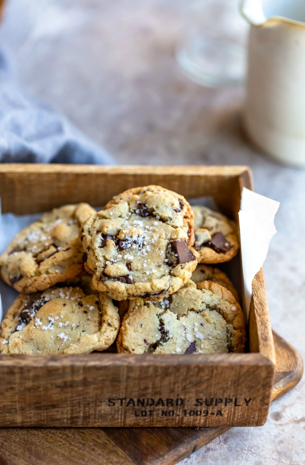 Pile of salted chocolate chip cookies in a wooden box