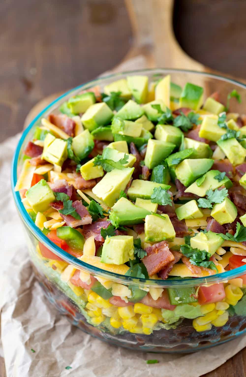 Southwestern Layered Salad in a glass trifle bowl. 