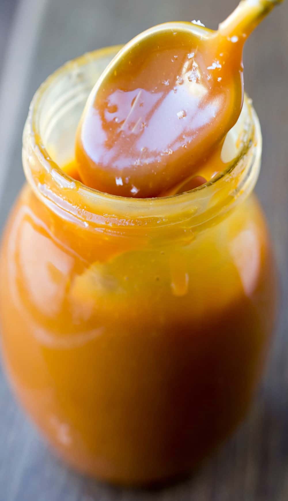 Spoon dipping up Salted Caramel Sauce