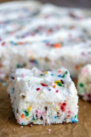 Slice of homemade funfetti cake on brown parchment paper