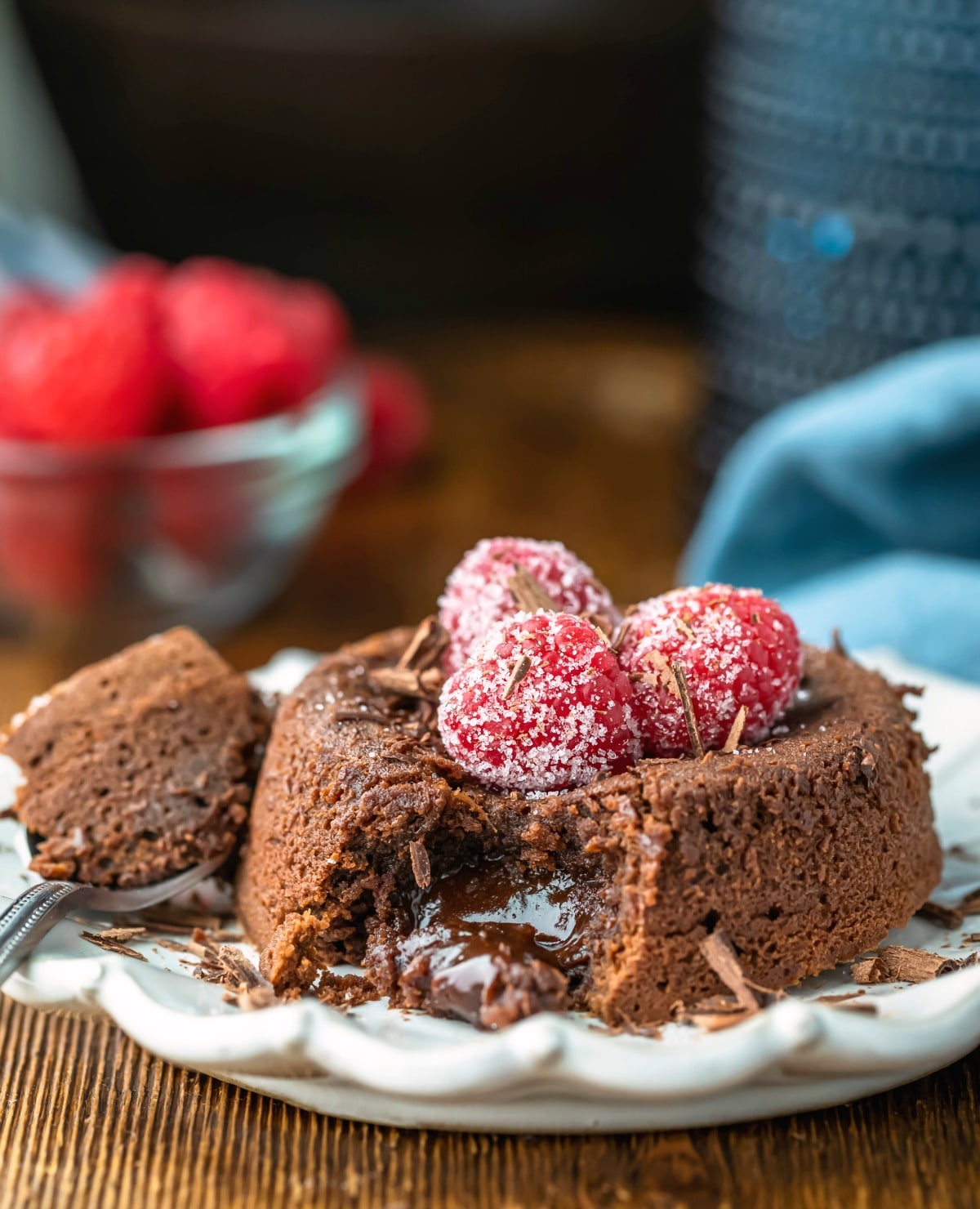 Molten chocolate cake on a cream plate topped with chocolate shavings