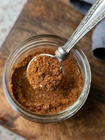Silver spoon scooping out taco seasoning
