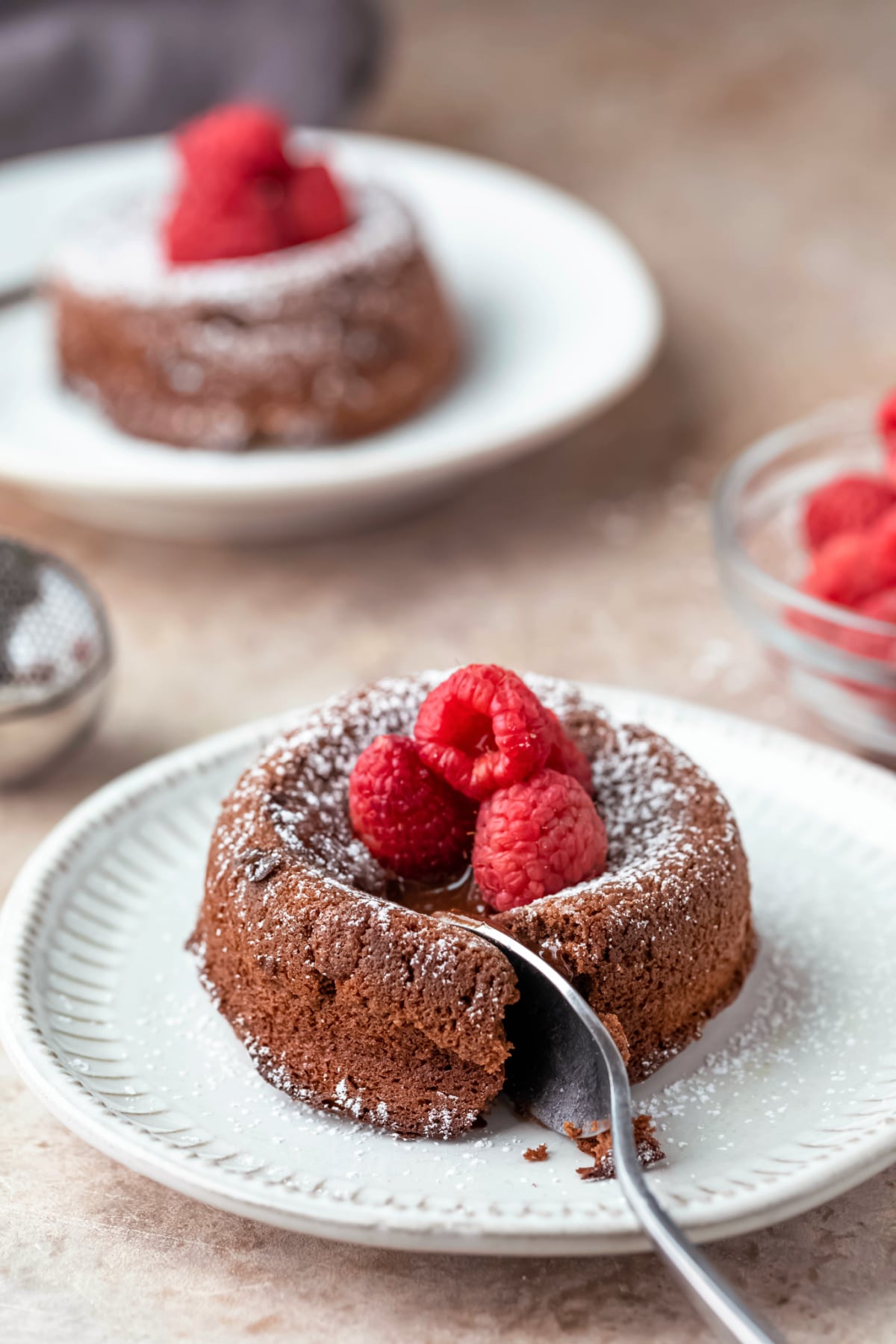 A spoon cutting a piece of molten nutella cake