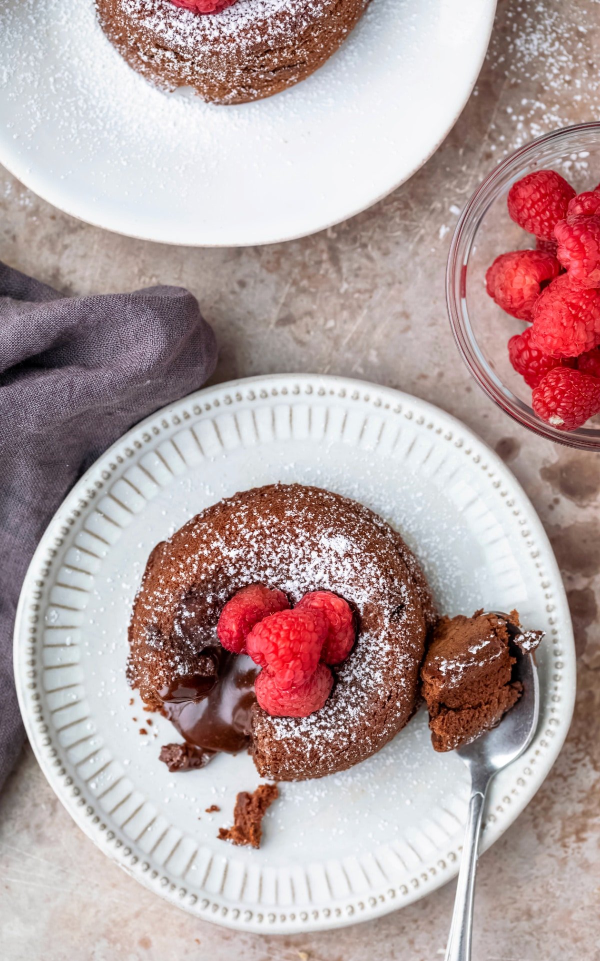 molten nutella cake on a plate with a spoon next to it
