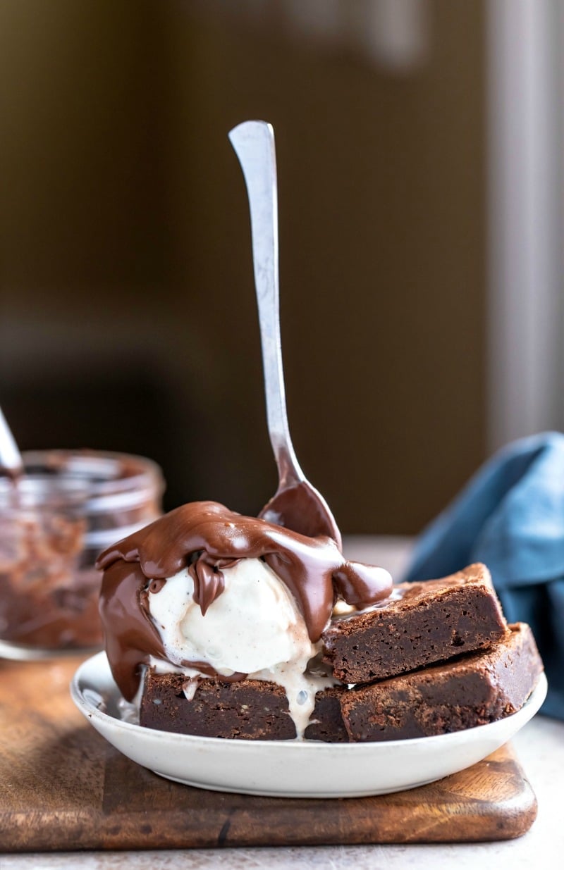 Fudge brownies topped with ice cream and hot fudge