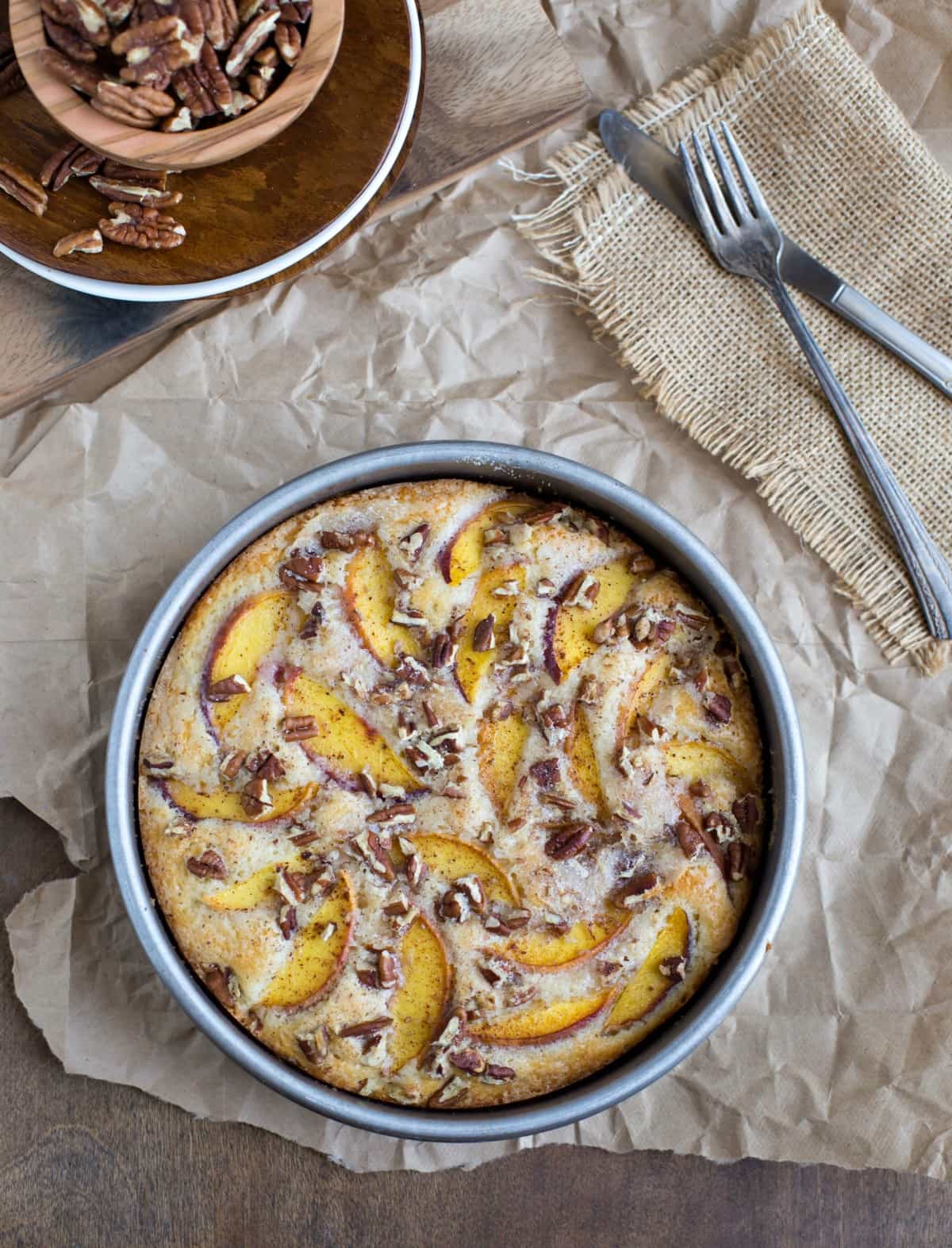 Peach cake in a round metal cake pan