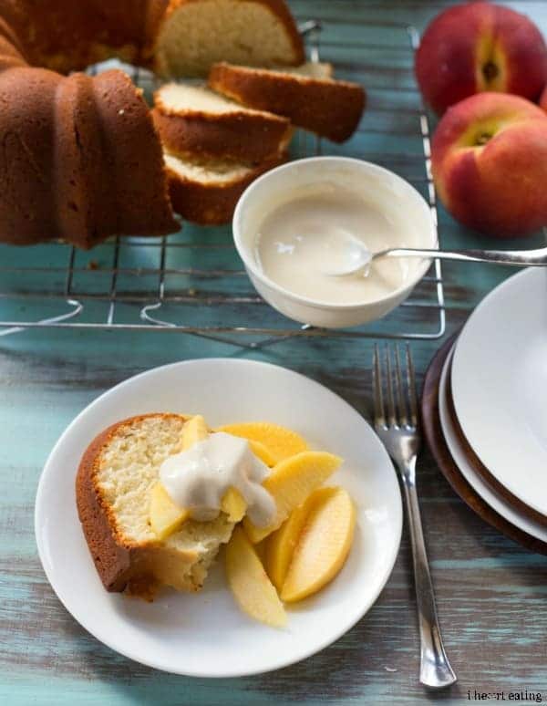 Slice of Greek Yogurt Pound Cake topped with peaches and cream