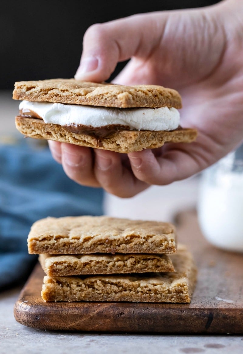 Hand holding a s'more made with homemade graham crackers