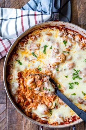 Spoon scooping up easy skillet lasagna from pan