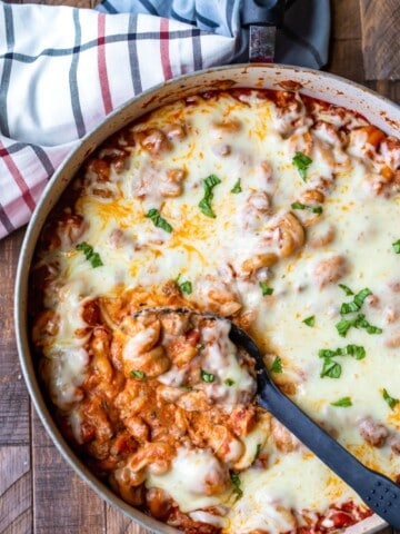 Spoon scooping up easy skillet lasagna from pan