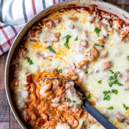 Spoon scooping up easy skillet lasagna from pan