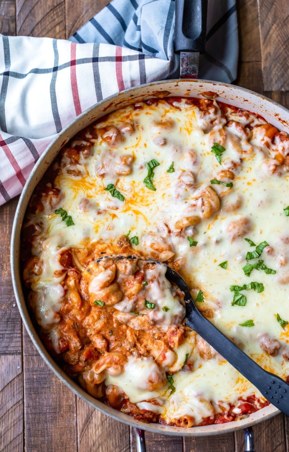 Spoon scooping up easy skillet lasagna from pan