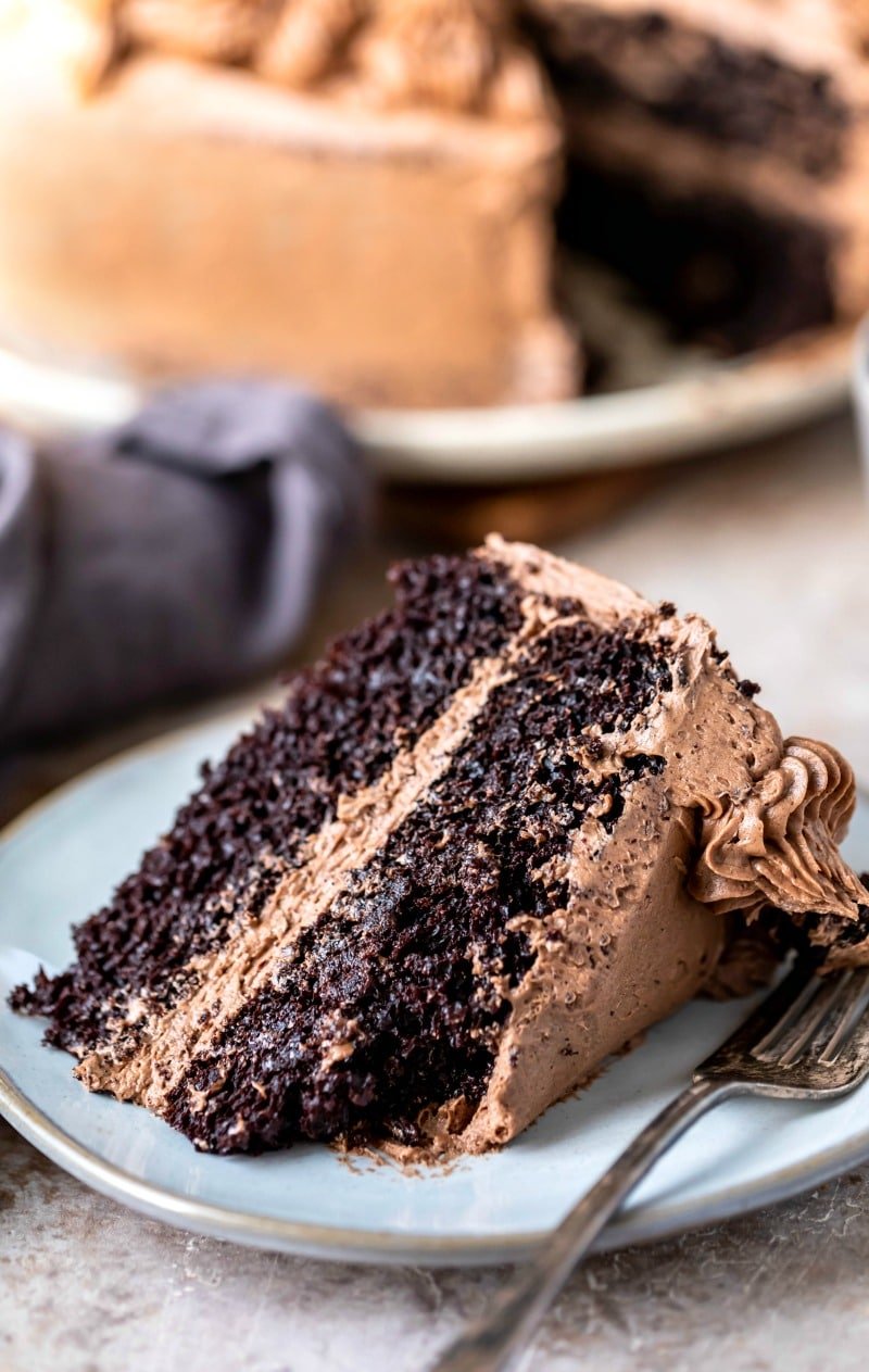 Fork with a piece of hot chocolate cake next to a slice of cake