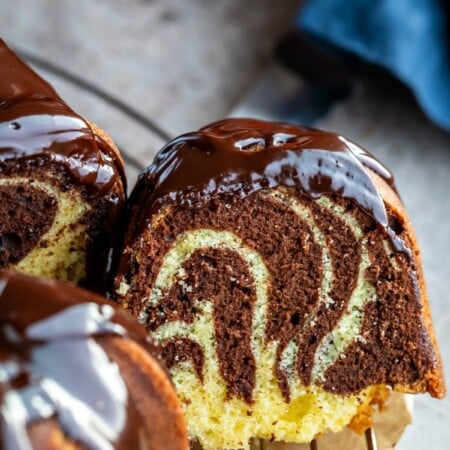 Slice of marble bundt cake cut from the cake