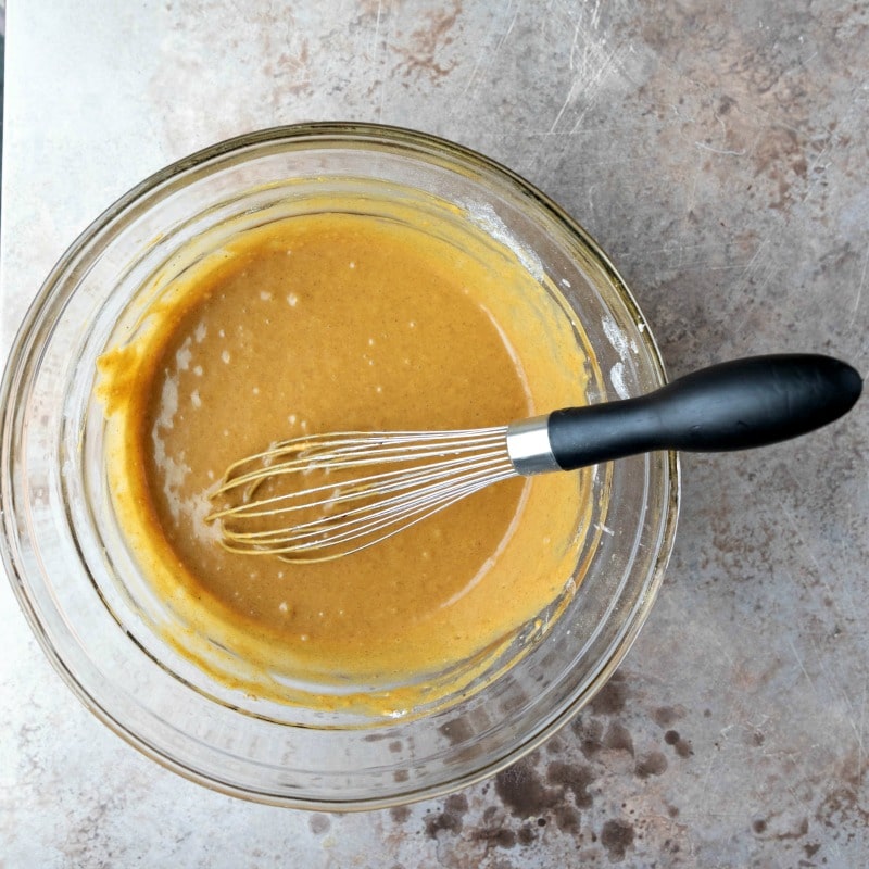 Gingerbread pancake batter in a glass mixing bowl