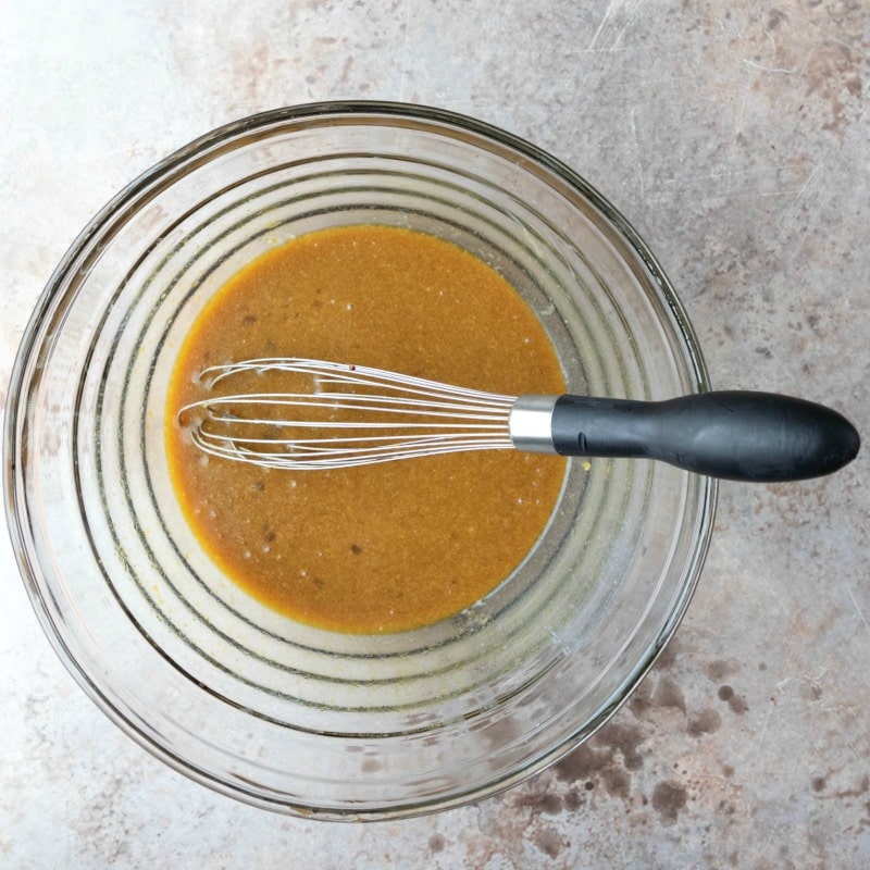 Sugar molasses eggs and butter mixed in a glass mixing bowl