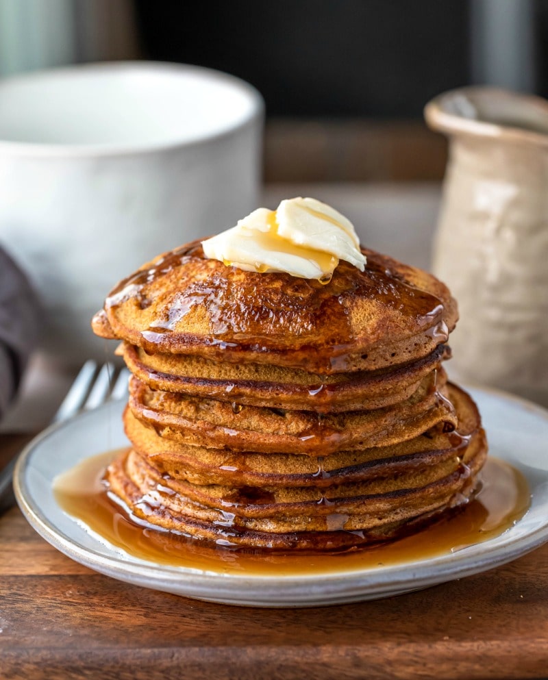 Stack of gingerbread pancakes with butter pats on top