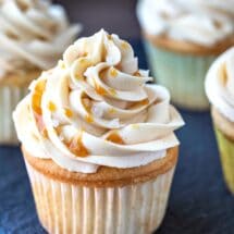 Caramel buttercream frosting topped with caramel sauce and grains of salt.